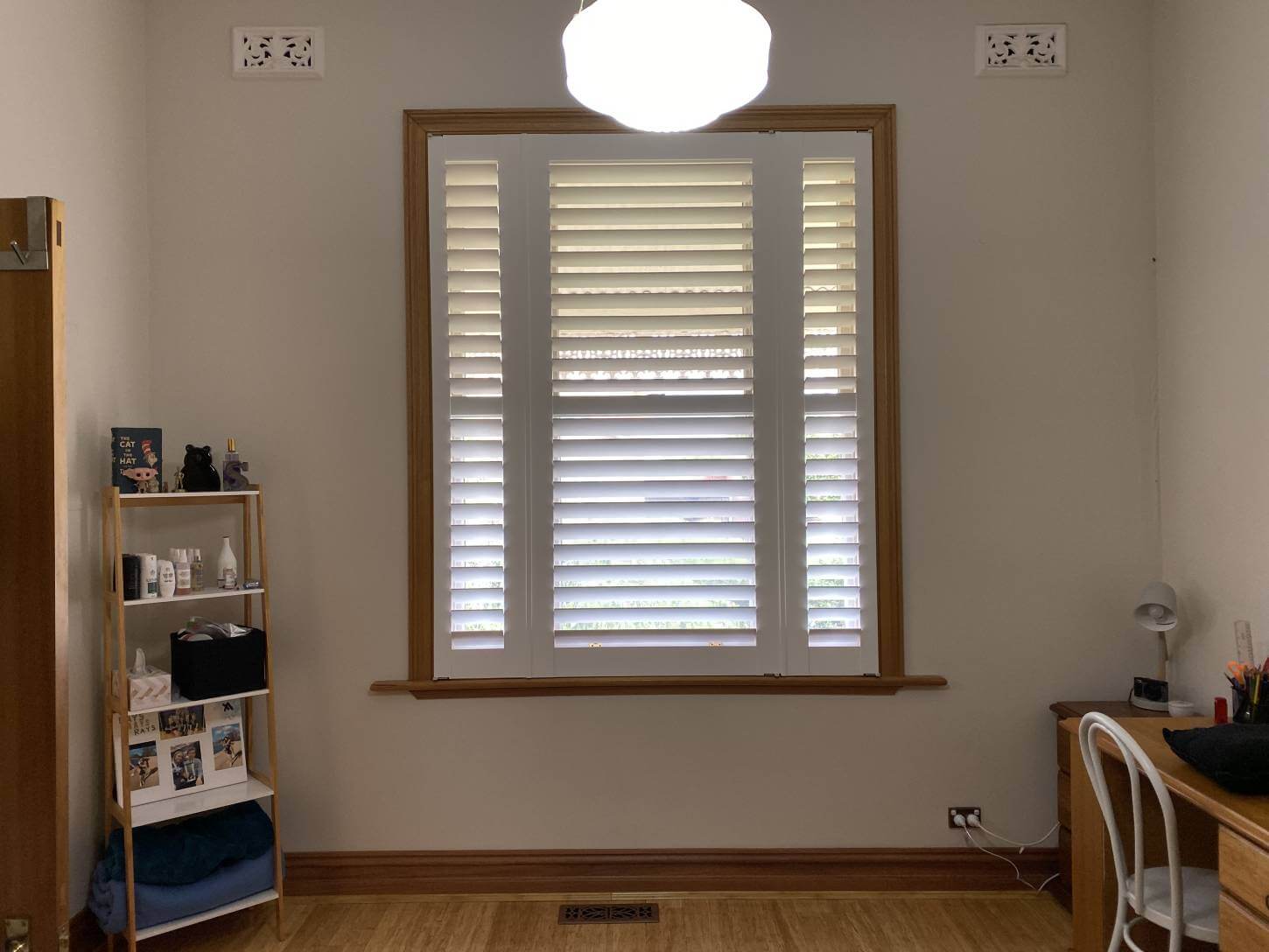 period home, sash window. white basswood timber shutters. two narrow shutters and one big one to suite the window. 89mm blades with mid rail done in yarravile