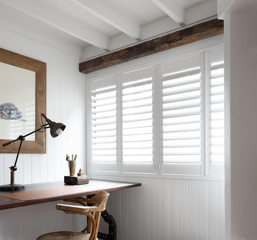 A room showcasing elegant white shutters.
